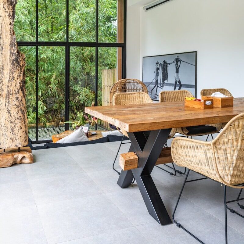 A dining room with a wooden table and chairs